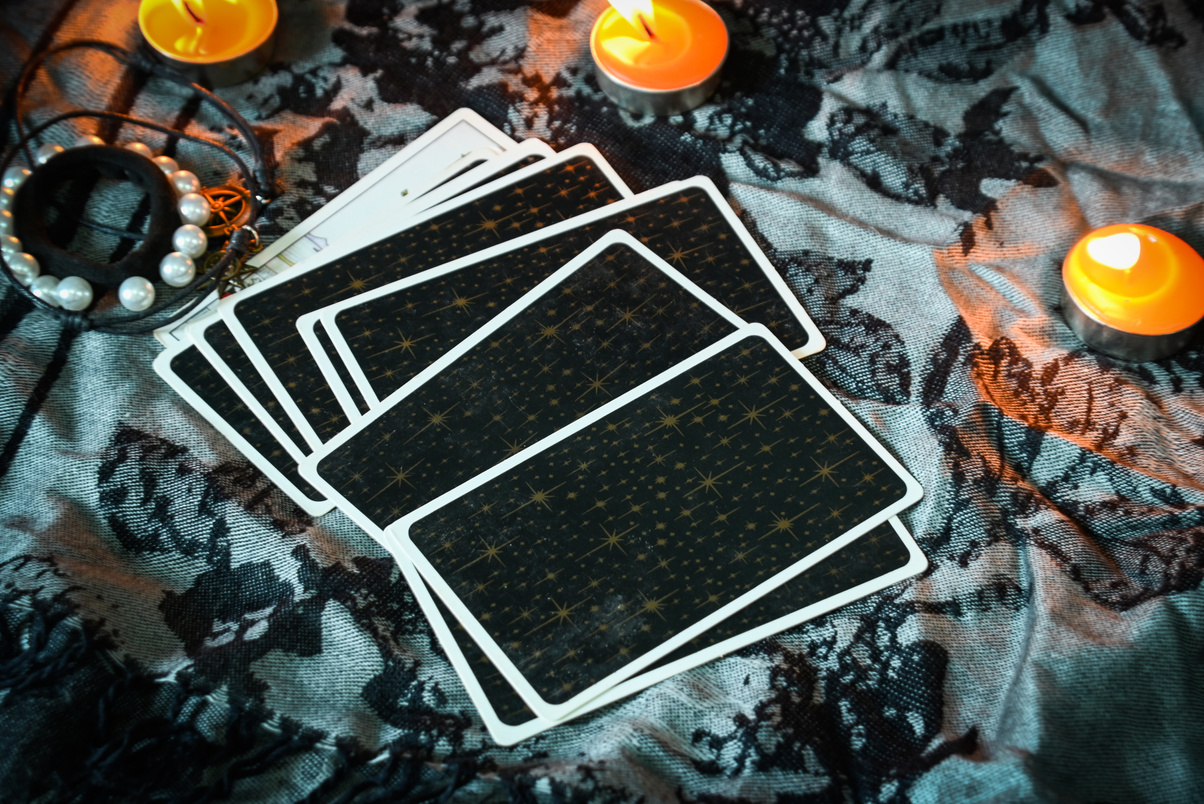 Tarot reading with tarot card background and candlelight on